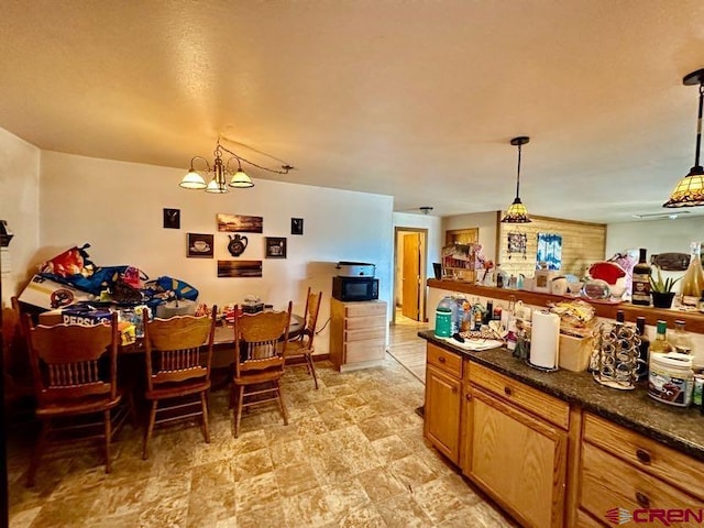 kitchen featuring a chandelier, light tile floors, and decorative light fixtures