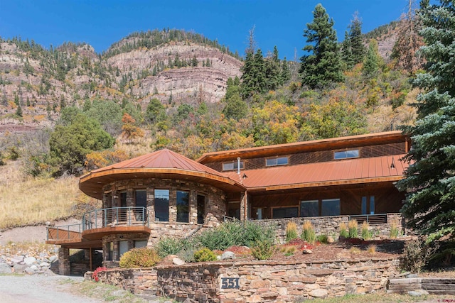 exterior space with a mountain view and a balcony