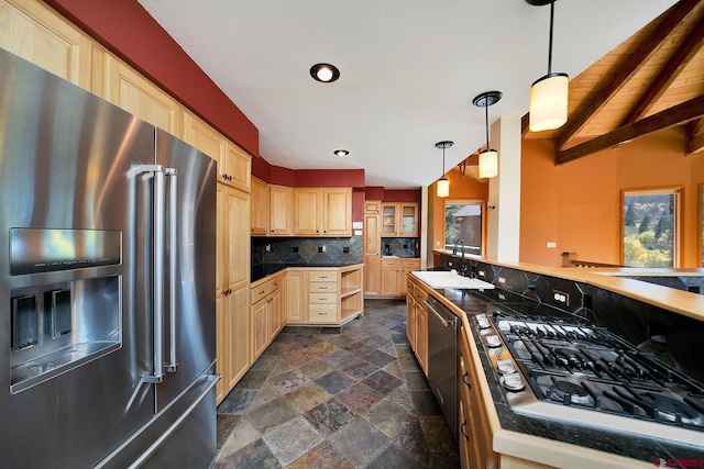 kitchen with dark tile floors, light brown cabinetry, appliances with stainless steel finishes, sink, and tasteful backsplash