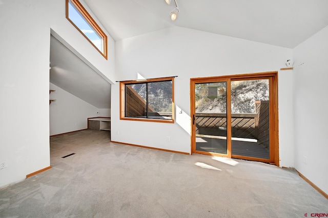 bonus room with light colored carpet and lofted ceiling
