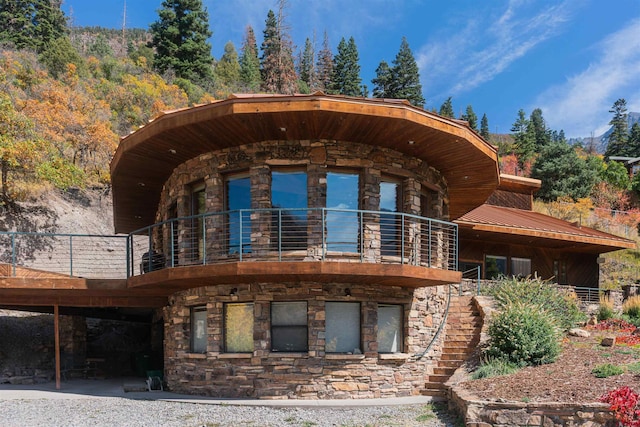 rear view of property with a balcony