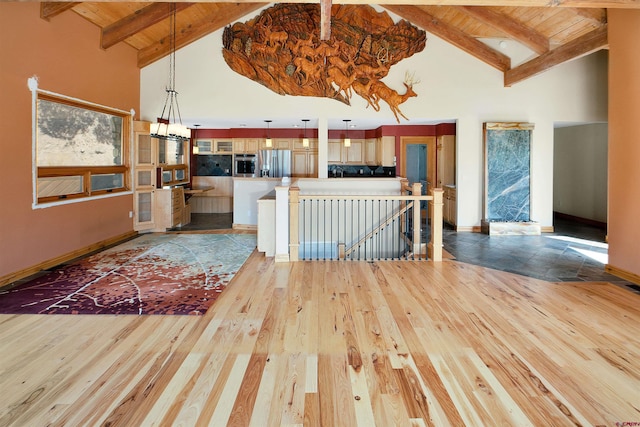kitchen featuring light hardwood / wood-style floors, beam ceiling, high vaulted ceiling, and stainless steel refrigerator with ice dispenser