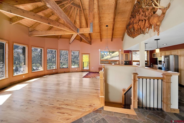 kitchen featuring pendant lighting, wood-type flooring, high end fridge, an inviting chandelier, and wood ceiling