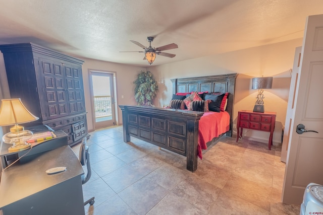 tiled bedroom featuring ceiling fan and a textured ceiling