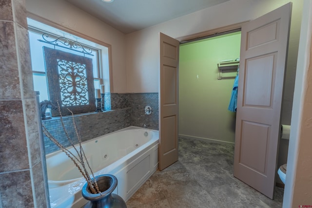 bathroom with a bathing tub, toilet, and tile flooring