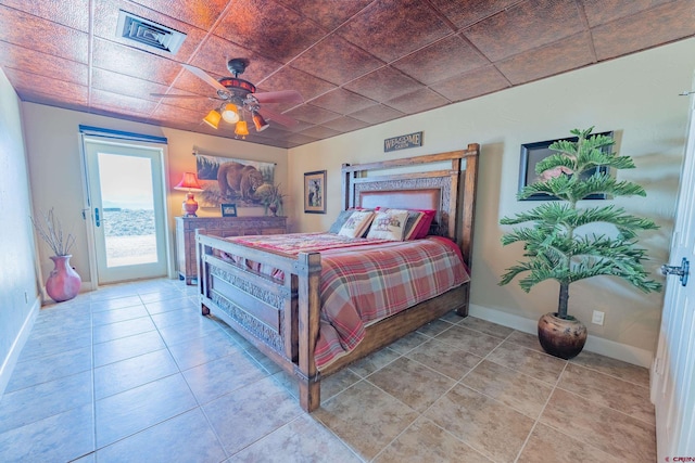 tiled bedroom with ceiling fan and access to outside