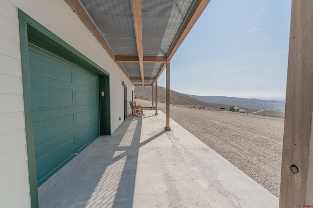 exterior space with a garage and a mountain view