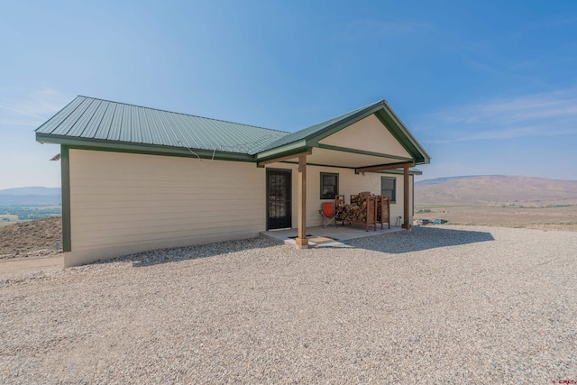 view of front of property with a patio area and a mountain view