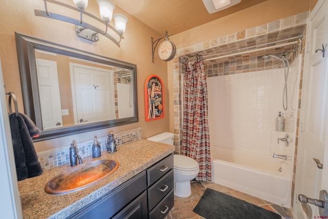 full bathroom featuring vanity with extensive cabinet space, toilet, tile floors, and shower / tub combo with curtain