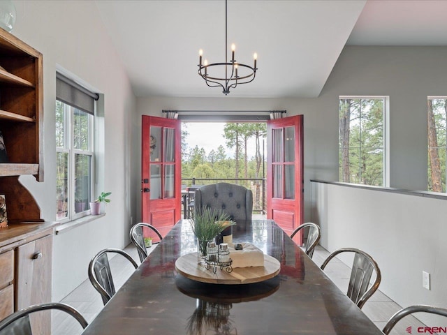 dining room featuring vaulted ceiling and an inviting chandelier