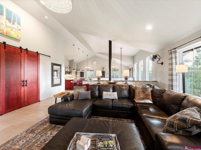 living room featuring hardwood / wood-style flooring, a barn door, and vaulted ceiling