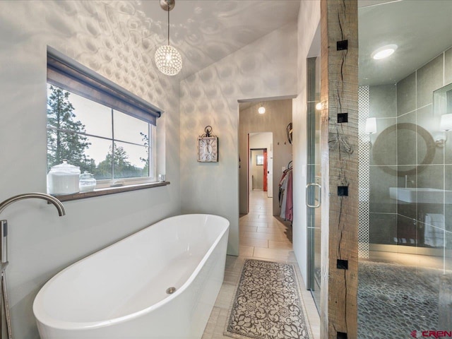 bathroom featuring tile flooring and shower with separate bathtub