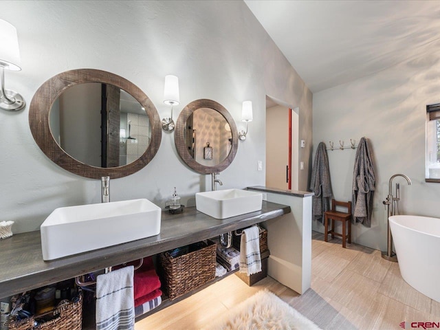 bathroom with a bathing tub and dual vanity