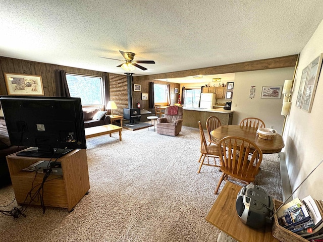 living room with ceiling fan, a healthy amount of sunlight, and carpet flooring