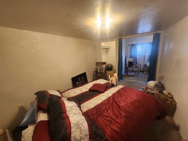 bedroom featuring carpet floors and a textured ceiling