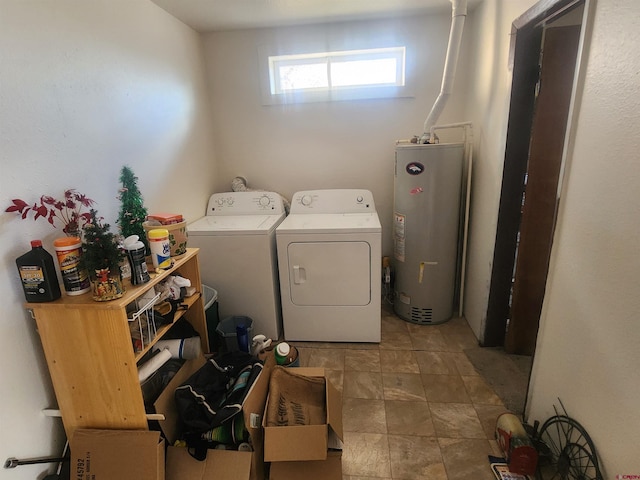 laundry room with gas water heater and washer and clothes dryer