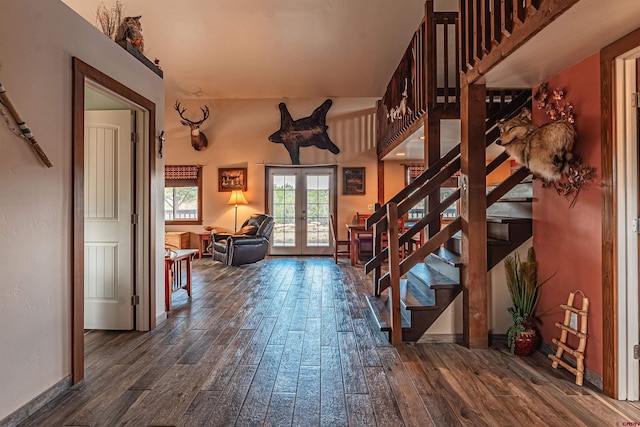 entrance foyer with dark hardwood / wood-style flooring and french doors