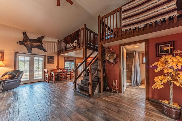 living room with hardwood / wood-style floors, french doors, and a towering ceiling