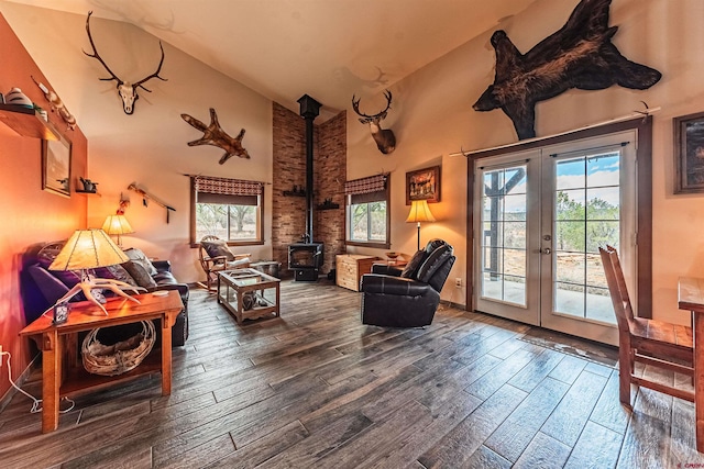 interior space featuring wood-type flooring, french doors, a wood stove, and a wealth of natural light