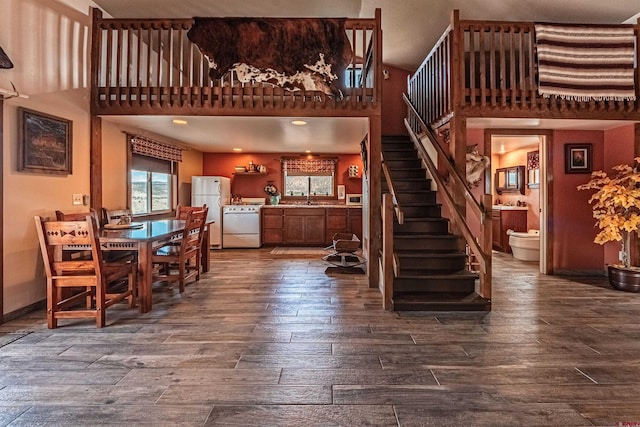 interior space featuring dark hardwood / wood-style floors, sink, and a high ceiling