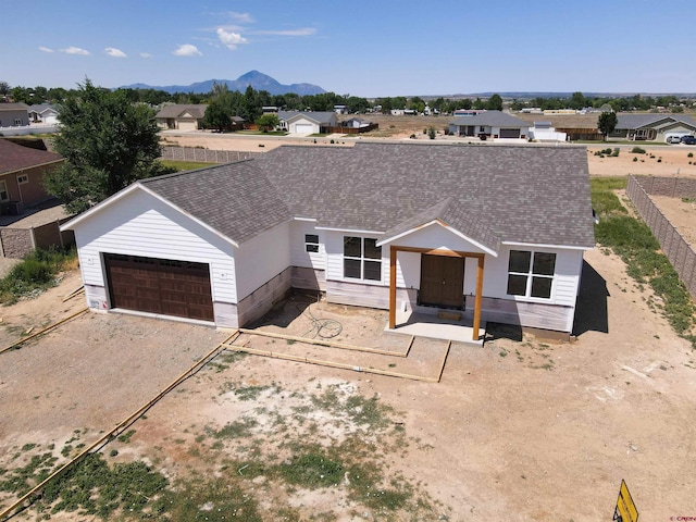 ranch-style house with a garage and a mountain view