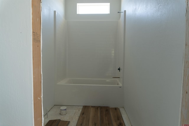 bathroom with wood-type flooring and shower / bath combination