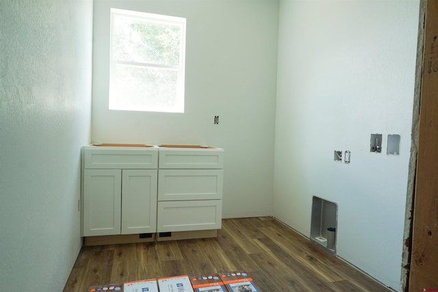 laundry room featuring dark hardwood / wood-style floors, washer hookup, and cabinets