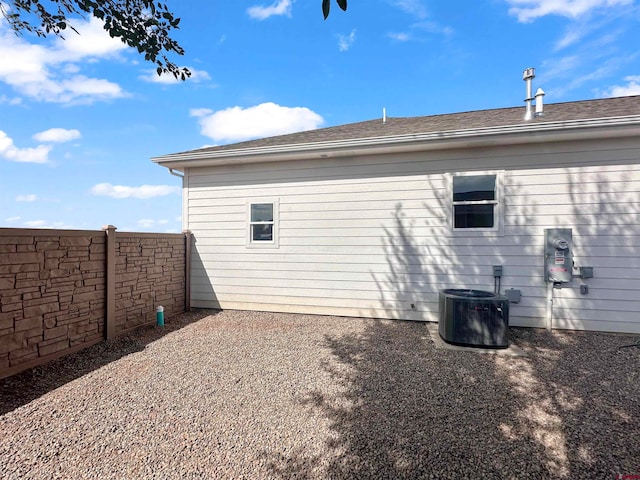 view of side of property with central air condition unit