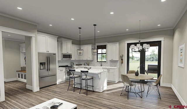 kitchen featuring stainless steel appliances, white cabinetry, a center island, and decorative light fixtures