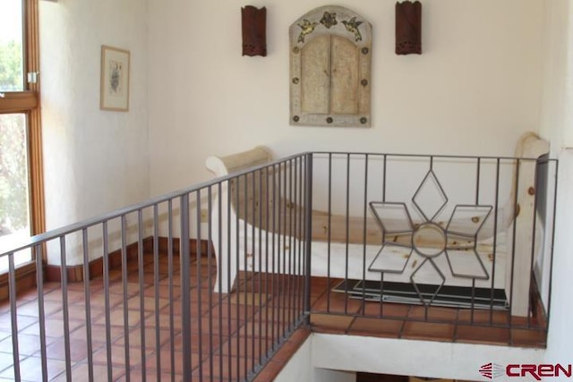 stairway with tile patterned flooring and a healthy amount of sunlight