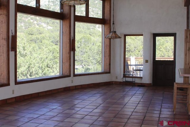 interior space with light tile patterned floors and a wealth of natural light