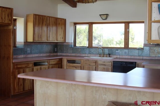 kitchen featuring black dishwasher, sink, kitchen peninsula, and backsplash