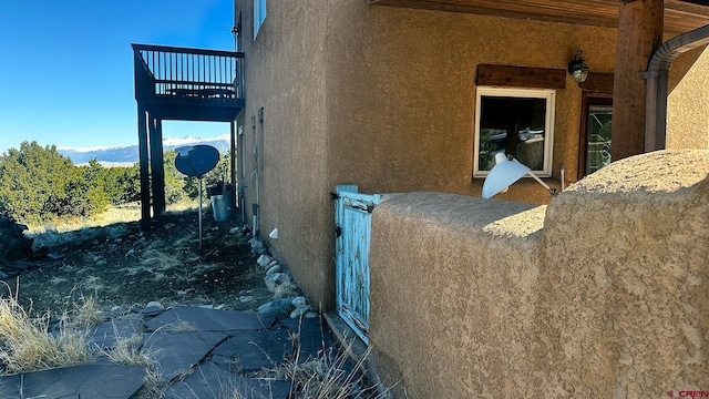 view of side of home with a balcony and a mountain view