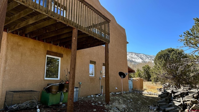 view of home's exterior with a deck with mountain view