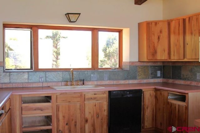 kitchen with black dishwasher, sink, and tasteful backsplash