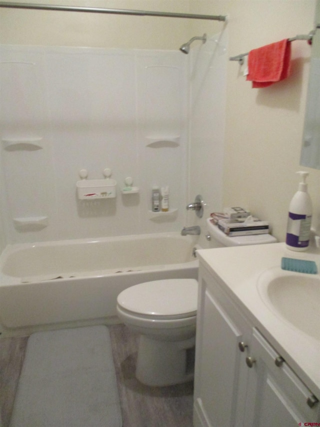 full bathroom featuring vanity, bathing tub / shower combination, and toilet