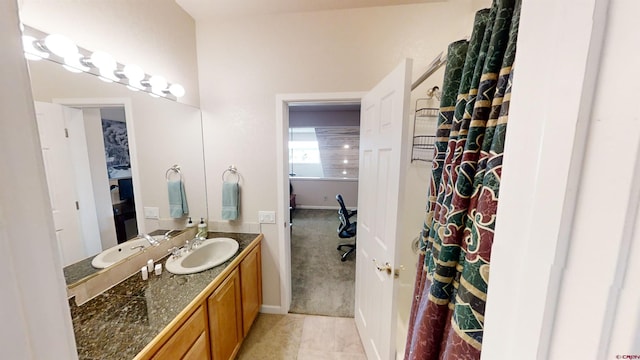 bathroom featuring tile flooring and vanity