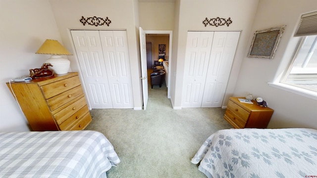 bedroom featuring two closets and carpet floors