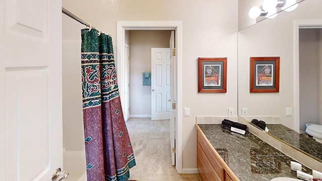 bathroom with vanity, toilet, and tile flooring