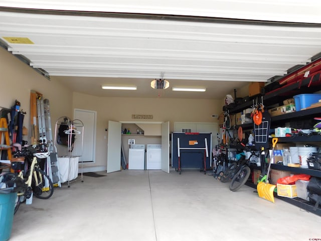 garage featuring separate washer and dryer and a garage door opener