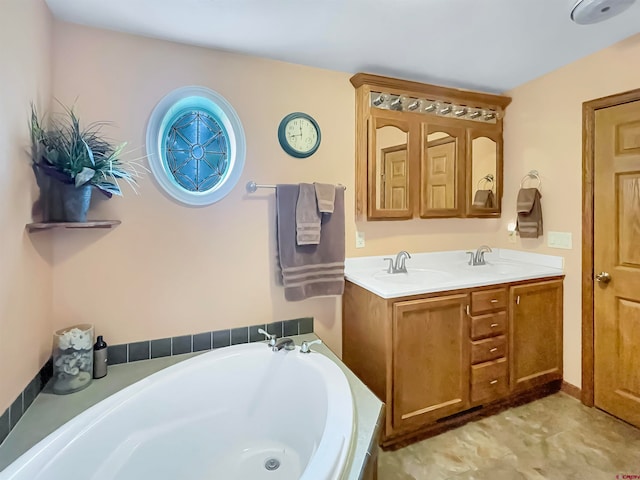 bathroom featuring a washtub and double vanity