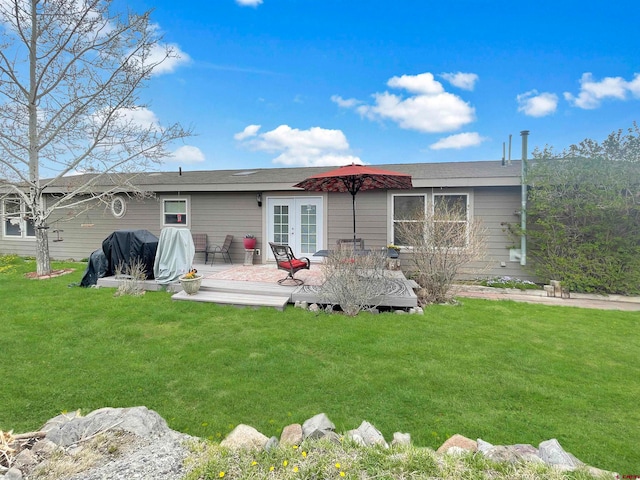 rear view of property featuring a lawn