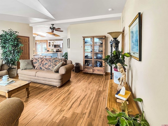 living room featuring a wealth of natural light, hardwood / wood-style floors, and ceiling fan