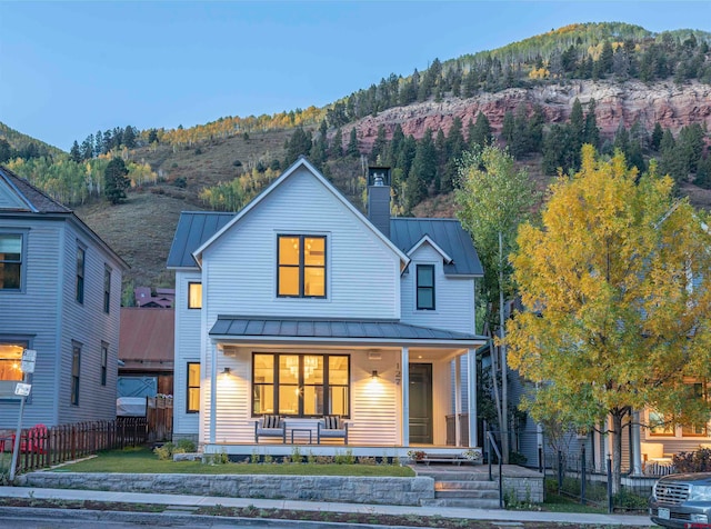 view of front facade featuring a mountain view and a porch