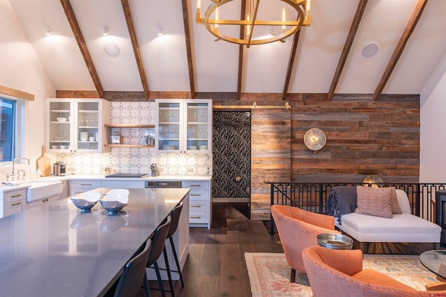 kitchen featuring tasteful backsplash, beam ceiling, a notable chandelier, dark hardwood / wood-style flooring, and sink