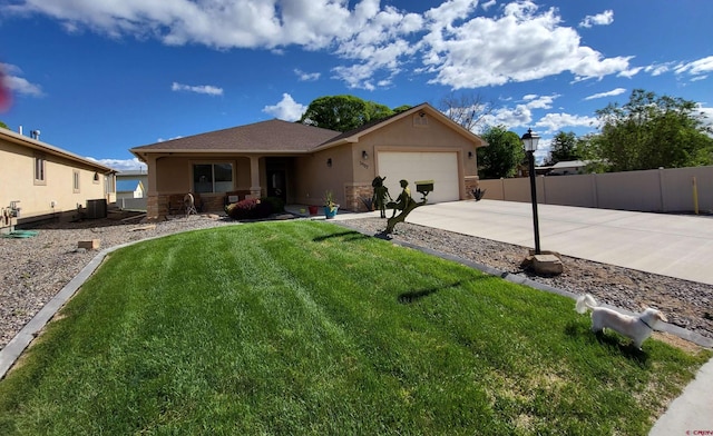 view of front of property with a front yard, a garage, and central AC unit