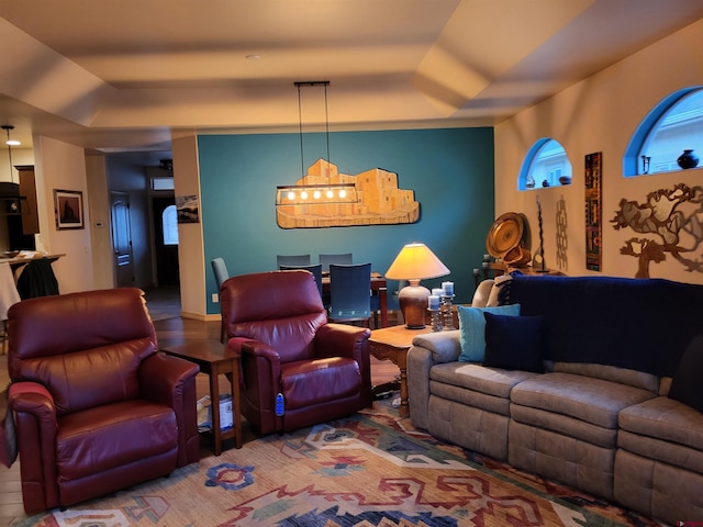 living room with a tray ceiling and hardwood / wood-style floors