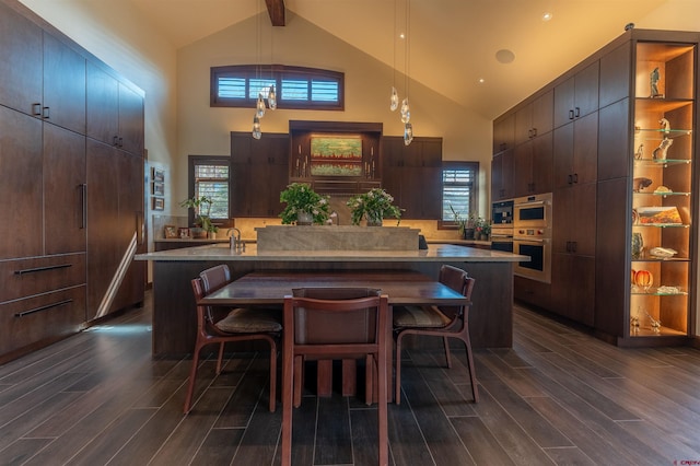 dining area with a healthy amount of sunlight, dark wood-type flooring, high vaulted ceiling, and beam ceiling