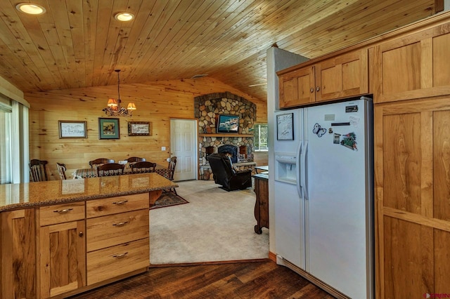 kitchen with wood walls, white refrigerator with ice dispenser, wood ceiling, dark carpet, and lofted ceiling