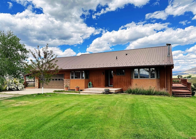 view of front of property featuring a garage and a front lawn